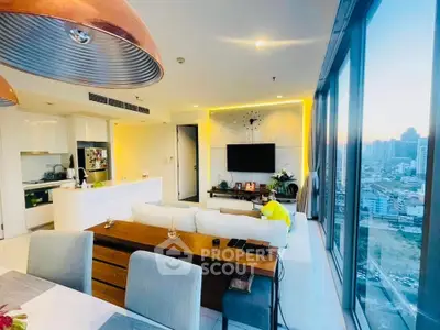 Luxurious living room with panoramic city view and modern open kitchen layout.