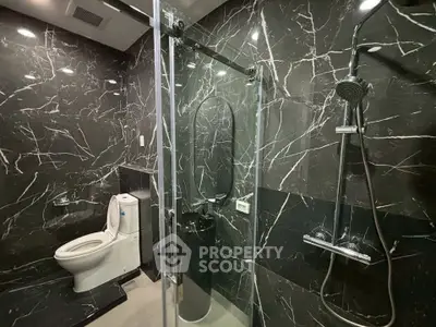 Luxurious black marble bathroom with modern shower and toilet