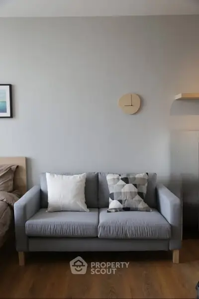 Modern living room with stylish gray sofa and decorative pillows