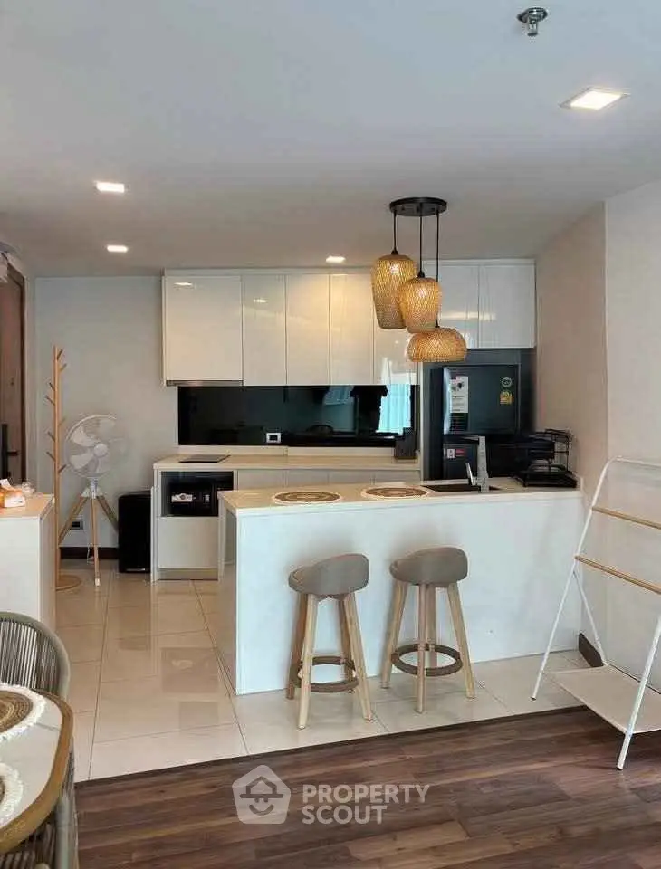 Modern kitchen with sleek white cabinets and stylish pendant lighting