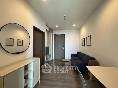 Modern living room with stylish decor and cozy seating in a contemporary apartment.