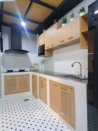 Modern kitchen with wooden cabinets and sleek black gas stove in stylish home.