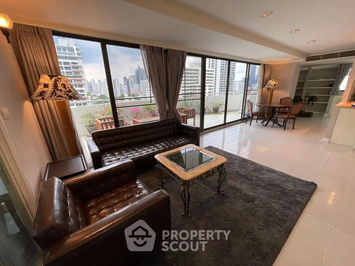 Spacious living room with stunning city view and elegant leather furniture