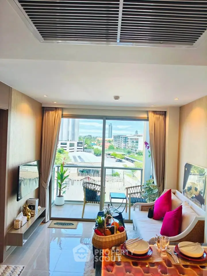Modern living room with balcony and city view, featuring stylish decor and natural light.