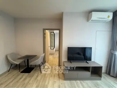 Modern living room with sleek furniture and air conditioning, perfect for comfortable living.