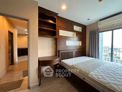 Spacious bedroom with built-in wooden shelves and large window offering city views.