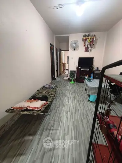 Spacious living room with modern flooring and minimalist decor, ideal for cozy living.