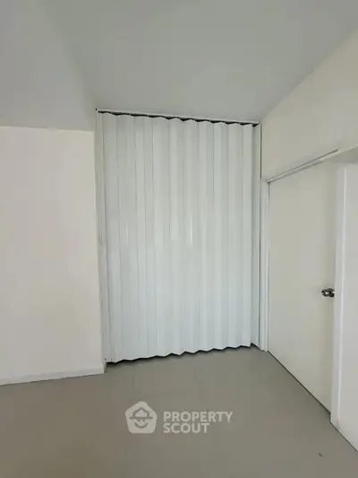 Minimalist interior with accordion door and sleek white walls
