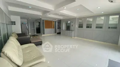 Spacious modern living room with elegant design and ample natural light.