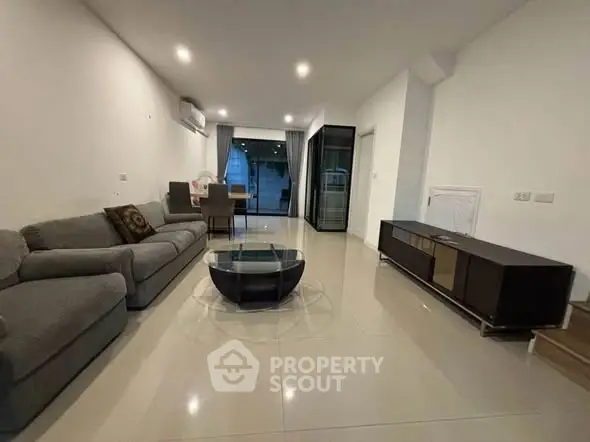 Spacious modern living room with sleek furniture and open layout, perfect for relaxation and entertainment.