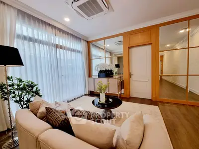 Elegant living room with modern decor and large windows for natural light.