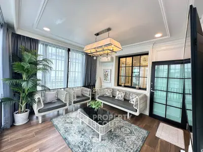 Luxurious living room with elegant decor and large windows offering natural light.