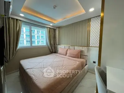 Luxurious bedroom with elegant decor and large window offering natural light.