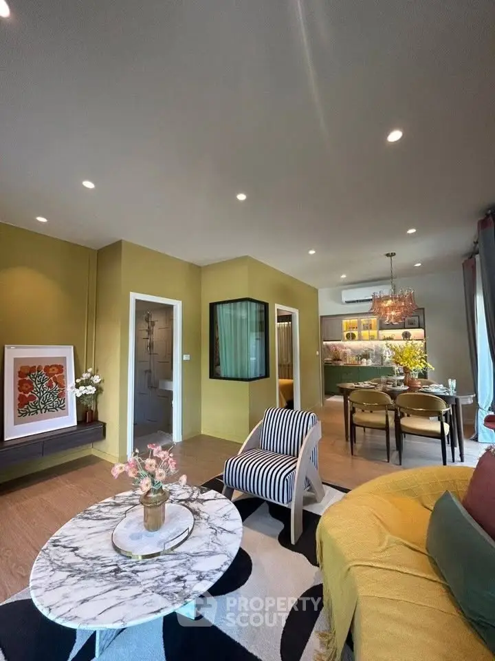 Stylish living room with modern decor and open layout, featuring elegant furniture and vibrant accents.