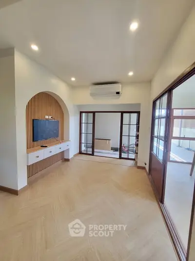 Spacious modern living room with wooden accents and large windows