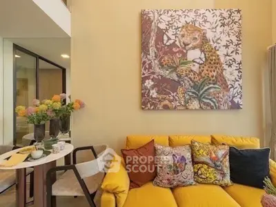 Stylish living room with vibrant yellow sofa and artistic wall decor
