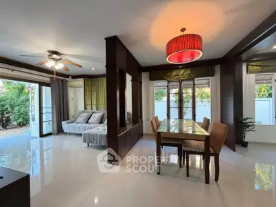 Spacious living and dining area with modern decor and garden view