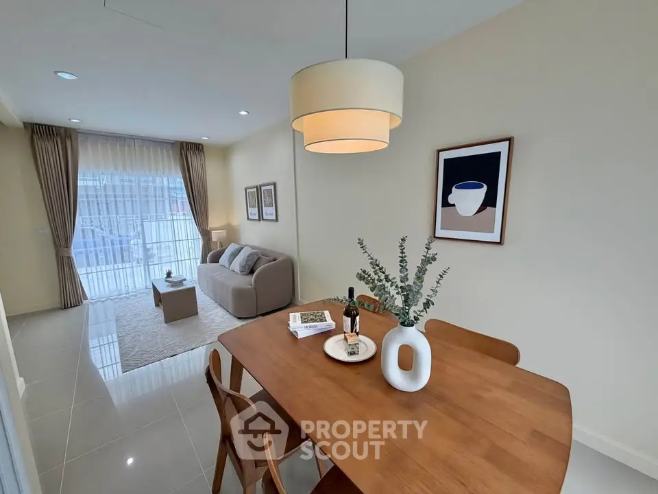 Modern living room with elegant dining area and cozy seating, perfect for relaxation and entertaining.