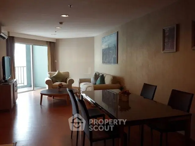 Spacious living room with modern furniture and balcony access in a stylish apartment.