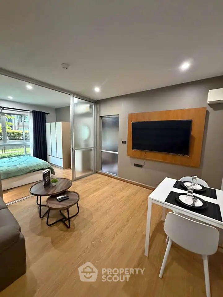 Modern studio apartment with open layout, featuring a cozy living area and stylish dining space.