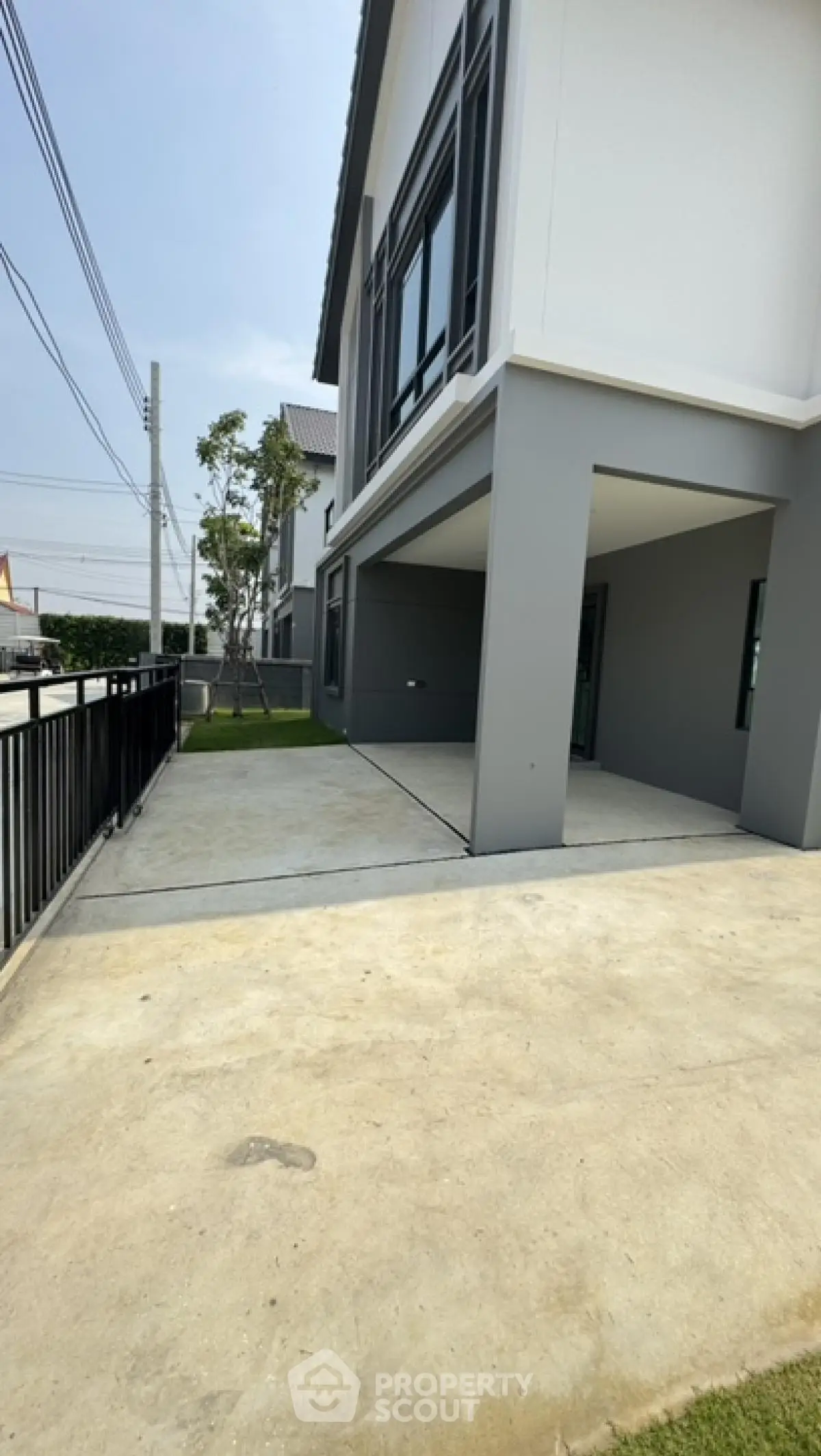 Modern two-story house with spacious driveway and sleek exterior design