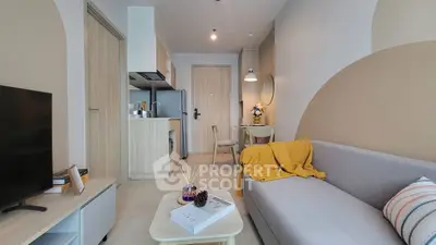 Modern living room with cozy sofa and stylish kitchen in open layout apartment.