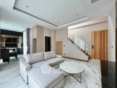 Modern living room with elegant staircase and marble flooring