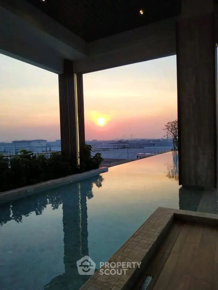 Stunning rooftop pool with breathtaking sunset view, perfect for luxury living.