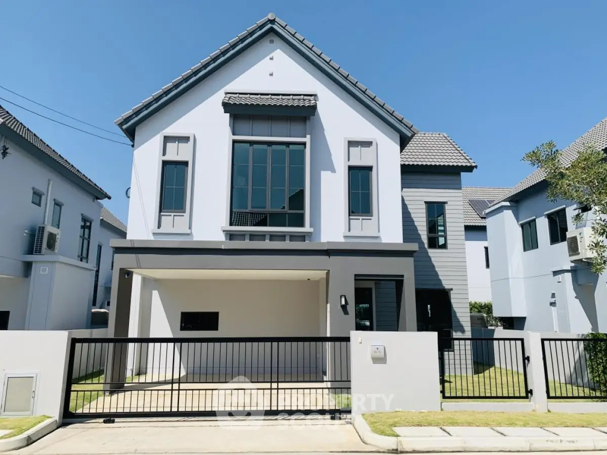 Modern two-story house with sleek design and spacious driveway in a serene neighborhood.
