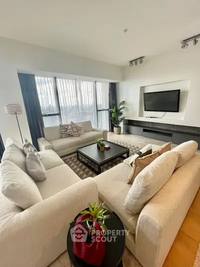 Spacious modern living room with elegant decor and large windows