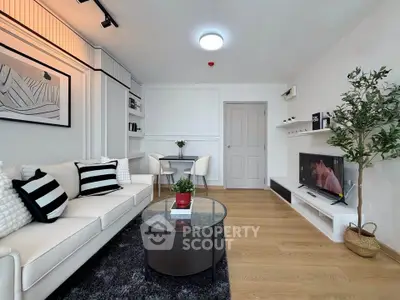 Modern living room with stylish decor, cozy seating, and a sleek TV setup, perfect for relaxation and entertainment.