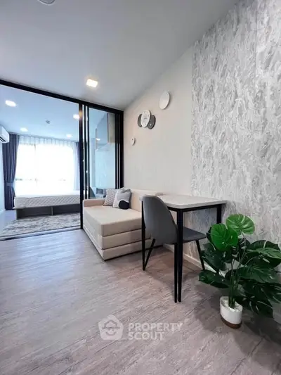 Modern apartment interior with stylish living area and bedroom, featuring elegant decor and natural light.