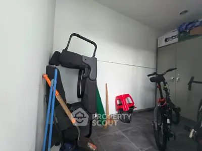Spacious storage room with bicycles and cleaning tools, ideal for organizing household items.
