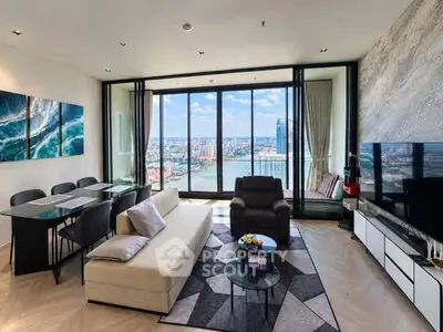 Luxurious living room with stunning city and river view, modern furniture, and elegant decor.