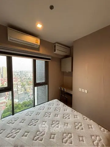 Modern bedroom with city view, featuring air conditioning and stylish decor, perfect for urban living.