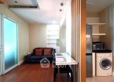 Modern living room with sleek furniture and built-in appliances, perfect for urban living.