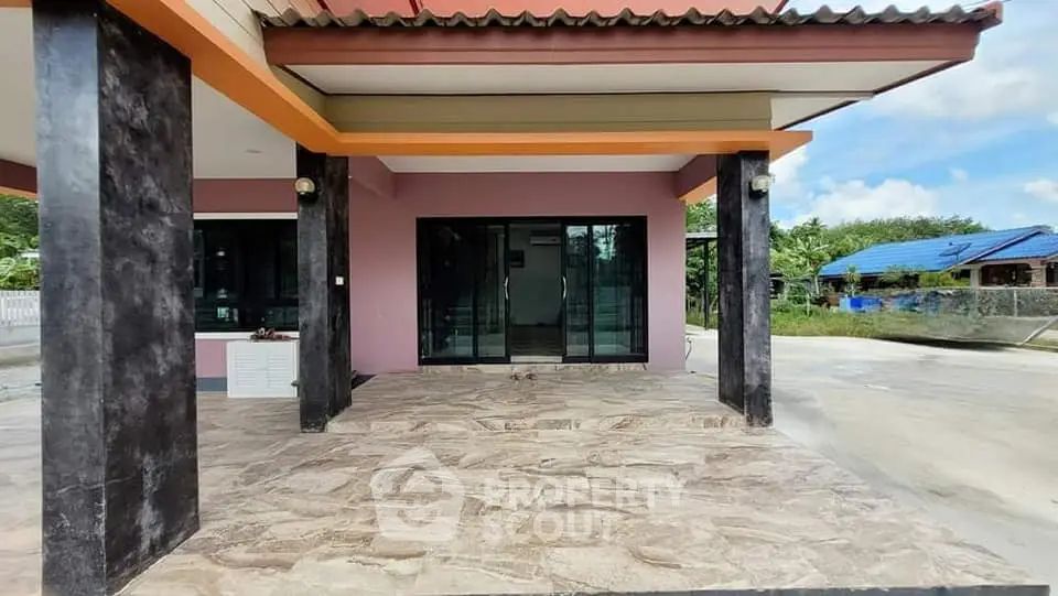 Modern house exterior with spacious patio and large glass doors