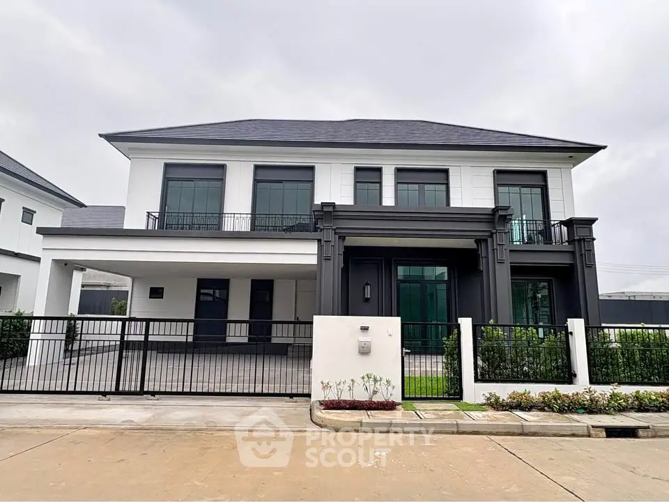 Modern two-story house with sleek design and spacious driveway