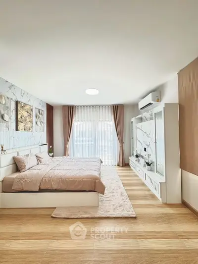 Spacious modern bedroom with elegant decor and natural light