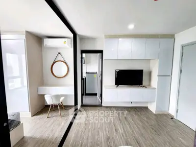 Modern living room with sleek design, featuring a TV, air conditioning, and stylish decor in a bright, open space.