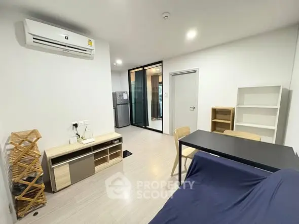 Modern living room with sleek furniture and air conditioning in a contemporary apartment.