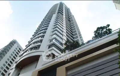 Stunning high-rise building with modern architecture and lush greenery, perfect for urban living.