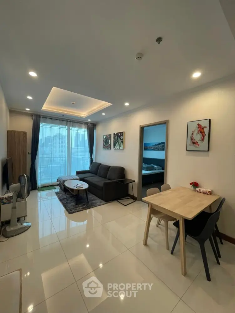 Modern living room with city view, stylish decor, and cozy dining area