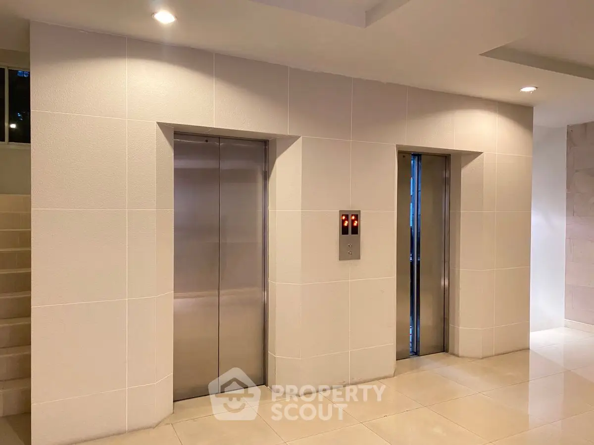 Modern building elevator lobby with sleek design and ambient lighting