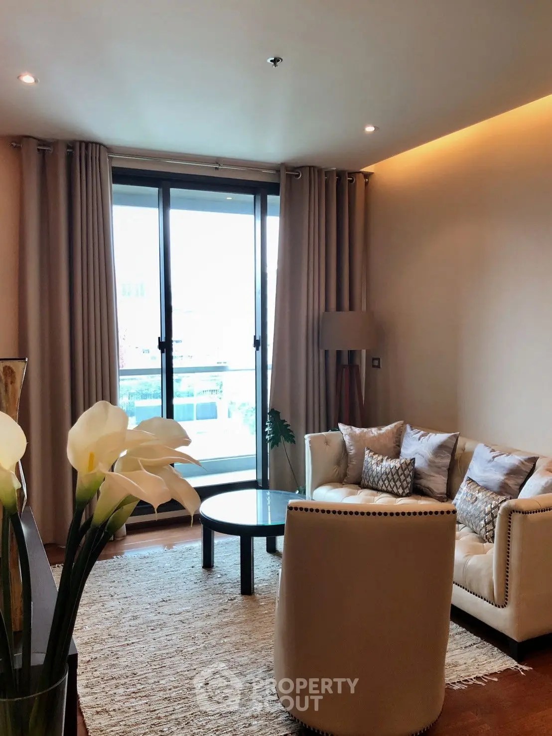 Luxurious living room with modern decor and large windows offering natural light.