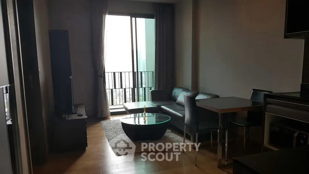 Modern living room with sleek furniture and balcony view