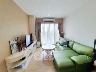 Charming living room with green sofa and natural light, perfect for relaxation.