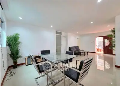 Spacious modern living room with sleek furniture and abundant natural light