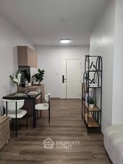 Modern apartment interior with stylish dining area and open layout, featuring elegant decor and wooden flooring.