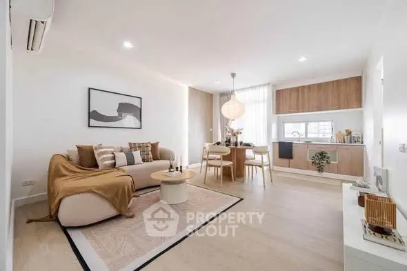 Modern open-plan living room with stylish decor and integrated kitchen area.